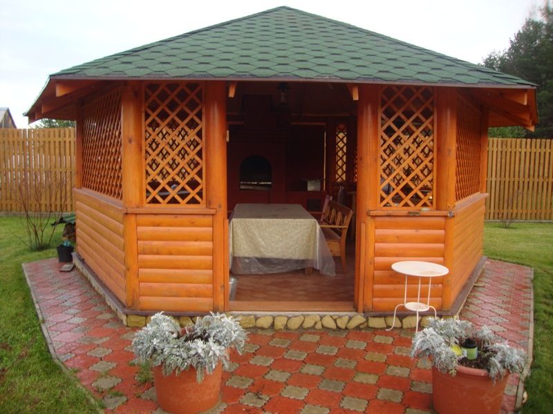 Beautiful handcrafted wooden gazebo in natural garden setting showcasing premium timber construction and traditional craftsmanship